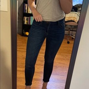 Classic dark wash skinny jeans with raw hem